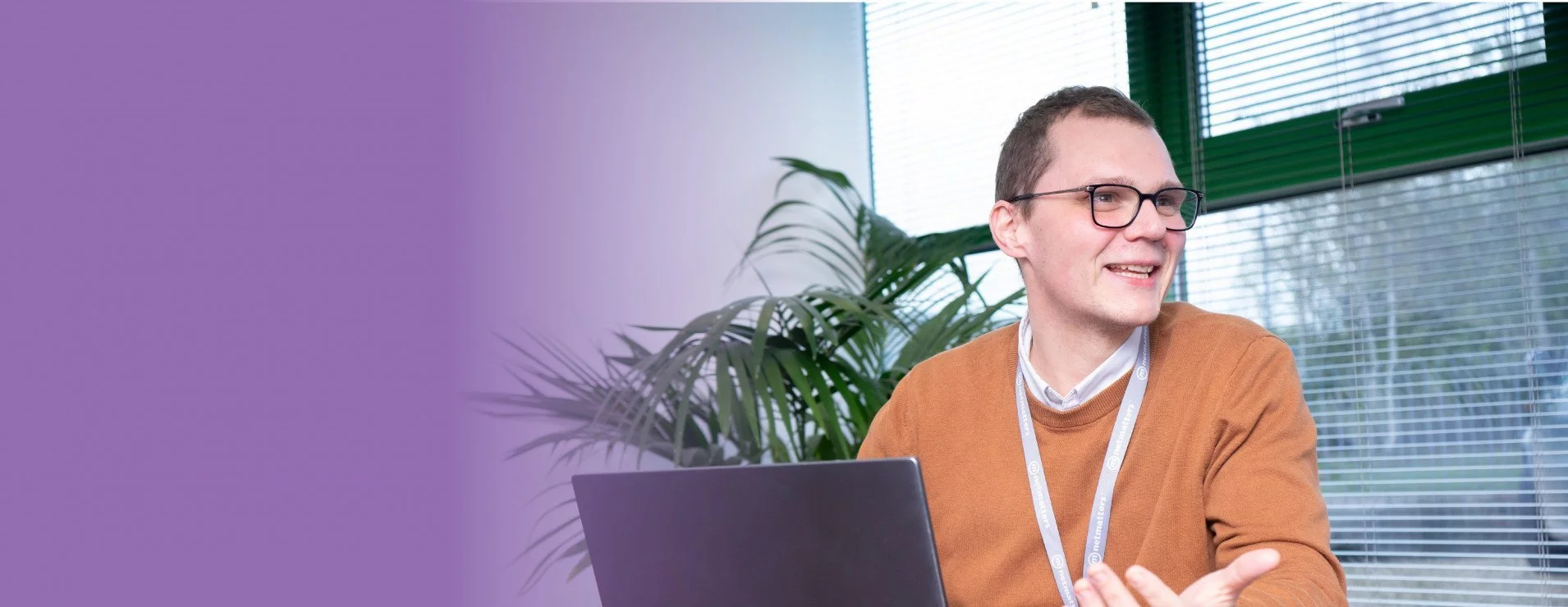 Developer at desk wearing lanyard